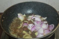 onions are being cooked in a pan on the stove