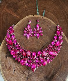 "Statement necklace and earrings set These fun and stylish pink teardrop cluster crystal rhinestone necklace and earrings set are a great statement piece!  Size of earrings: 2\" Long.  Necklace 17\"long with 3\" chain extender Decor Size: 2.5\" Color: hot pink/fuchsia rhinestones  Base metal color: silver More colors available upon request, just message us! Need a matching bracelet? https://www.etsy.com/listing/607744629/fuchsia-bracelet-hot-pink-bracelet?ref=shop_home_active_59 https://etsy.me/2UTFrJ4  https://etsy.me/2VJu5W8  https://etsy.me/3hBB6Uo  Looking for the perfect pair of earrings for a special occasion. We specialize in custom work in fashion jewelry, pearls, and natural stones! Please feel free to browse through our other listings, and if you can't find what you are looking f Pink Crystal Rhinestone Necklace In Glamorous Style, Glamorous Pink Rhinestone Necklace For Party, Pink Teardrop Crystal Jewelry, Pink Rhinestone Necklace For Party, Pink Crystal Rhinestone Necklace, Pink Crystal Glamorous Necklace, Pink Crystal Jewelry Sets With Rhinestones, Pink Rhinestone Jewelry Set For Party, Glamorous Pink Rhinestone Necklace