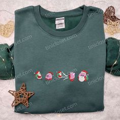 a green shirt with christmas decorations on it