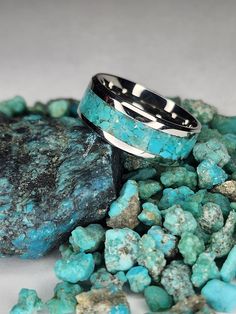 -Gorgeous Kingman Turquoise inlayed in a stainless steel band. -The Kingman Turquoise Mine is one of the oldest and highest producing Turquoise Mines in America. It was originally discovered by prehistoric Native Americans well over 1000 years ago. -All rings are unique and no two rings will be exactly the same. -Made with 100% Genuine Kingman Turquoise from Kingman, Arizona. -8mm wide band 4 mm wide inlay. -Handmade to order. -Unisex -(See last two photos for sizing). Turquoise Stainless Steel Jewelry As Gift, Turquoise Stainless Steel Jewelry Gift, Turquoise Stainless Steel Jewelry As A Gift, Kingman Arizona, 1000 Years, Sleeping Beauty Turquoise, Kingman Turquoise, Blue Band, Raw Stone