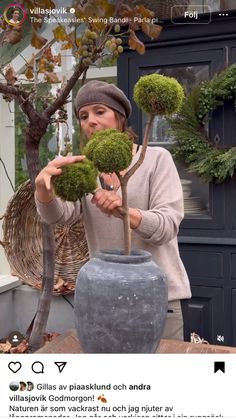 a woman holding up a potted plant in front of her face with the caption's name on it