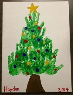 a handprint christmas tree is displayed on a card