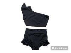 Brief has ruffles, and top has a single flutter sleeve. Stretchy and has great coverage as well! Black Stretch Tops For Cheerleading, Black Tops For Cheerleading In Summer, Black Cheerleading Tops For Summer, Black Tops For Summer Cheerleading, Black Ruffled Stretch Swimwear, Fitted Black Dancewear Top, Black Dancewear Tops For Dance, Stretch Black Tops For Dance, Black Stretch Tops For Dance