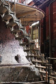 an old spiral staircase in the middle of a building