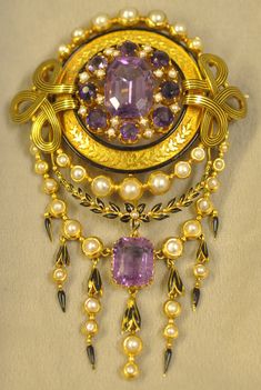 This is a rare beautiful pendant and brooch. Made of 18K in yellow gold. Set in the pendant brooch is amethyst and pearls accented with enamel. I Exquisite Jewel Pendant Brooches, Exquisite Pendant Brooches With Jewels, Exquisite Jeweled Pendant Brooches, Victorian Pendant Brooch With Jewels, Antique Pendant Brooches With Gemstone, Elegant Purple Gemstone Brooches, Exquisite Collectible Jewelry Brooch, Antique Jeweled Pendant Brooches, Exquisite Collectible Brooch Jewelry