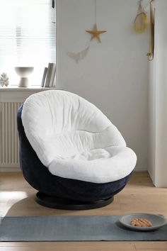 a white and blue chair sitting on top of a wooden floor