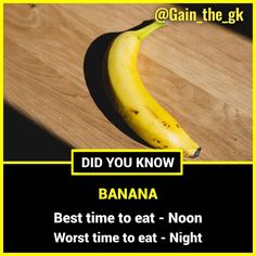 a banana sitting on top of a wooden table next to a sign that says did you know banana best time to eat - noon worst time to eat - night