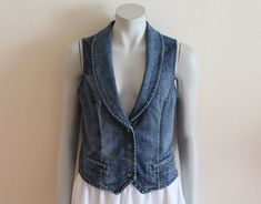 "Women's Vest Denim Vest Blue Denim Vest Fitted Jeans Waistcoat Metal Buttons Womens Country Western Boho Sleeveless Jean Jacket Medium Size Measurements (lying flat): Length(back): 19 1/4\"/ 49 cm Pit to pit: 17.5\"/ 44.5 cm Waist: 16\"/ 40.5 cm Condition: Great Vintage Condition Please check measurements to insure a proper fit. Remember to allow yourself some extra room for movement. You can compare these with something from your closet that fits you well. Please convo me if you need additiona Sleeveless Dark Wash Spring Outerwear, Fitted Dark Wash Denim Vest For Spring, Fitted Sleeveless Dark Wash Denim Jacket, Spring Dark Wash Denim Vest Top, Fitted Medium Wash Vest, Fitted Dark Wash Vest, Fitted Sleeveless Denim Jacket For Spring, Fitted Denim Blue Vest For Spring, Fitted Medium Wash Vest For Spring