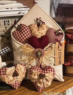 some heart shaped decorations are sitting on a table next to jars and other decorative items