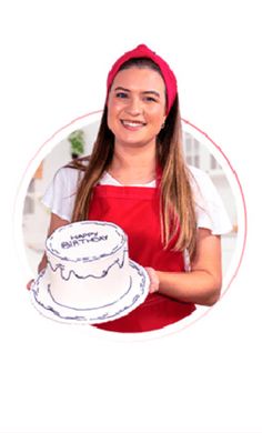 a woman in an apron holding a cake