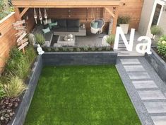 a small backyard with grass and stone steps