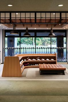 a large room with lots of wooden furniture and lights hanging from the ceiling above it