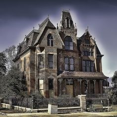 an old house with a clock tower on top