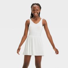 Why we're ALL IN: Solid-color sleeveless active dress with built-in shorts and a pleated skirt. Made from recycled polyester fabric with added spandex for flexible wear. Boasts moisture-wicking and quick-drying construction for comfort during any activity. The hidden pocket, built-in shorts, V-neckline and keyhole cut-out back complete the sporty design. All in Motion™: Inspiring the potential in every body. Sleeveless Summer Dress With Built-in Shorts, Summer V-neck Stretch Activewear, Summer Athleisure Dresses With Built-in Bra, Sleeveless Stretch Tennis Dress With Built-in Bra, Workout Dress With Built-in Stretch Shorts, Solid Tennis Dress With Built-in Shorts For Summer, White Tennis Dress With Built-in Shorts For Summer, Stretch Mini Dress With Built-in Shorts, Sleeveless Tennis Dress With Built-in Shorts