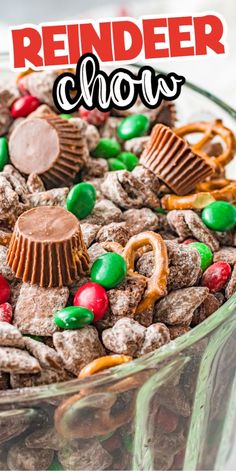 a glass bowl filled with candy and pretzels for reindeer chow, on top of a white table