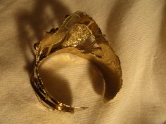 "I purchased this bracelet in the 1990's. It's made of a light flexible metal with gold finish. It is 2\" wide at the highest point. The only label is the faded Made in Mexico sticker. It's big on me so would fit a larger wrist nicely. Light scratches. I ship same or next business day." Collectible Handmade Gold Bangle, Handmade Gold Bangle For Collectors, Vintage Gold Hand Cast Cuff Bracelet, Adjustable Gold Artistic Cuff Bracelet, Unique Gold Cuff Bracelet For Collectors, Gold Bangle Cuff Bracelet In Wearable Art Style, Handcrafted Leather Wallet, Fun Wallets, Metal Cuff Bracelet