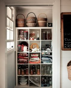 a pantry with baskets and food items on shelves