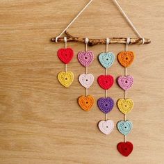 crocheted hearts hanging on a wooden stick