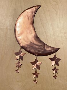 a metal crescent with stars hanging from it