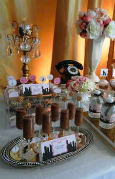 a table topped with lots of cupcakes and cakes