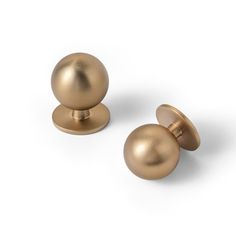 two brass knobs on white background with clipping to the top one for each door