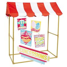 a red and white striped tent sitting on top of a metal stand with stickers