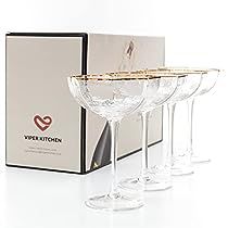 three wine glasses sitting next to each other in front of a box on a white surface