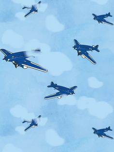 several blue airplanes flying in the sky with hearts on it's back and sides