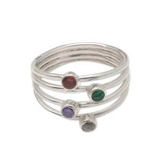 A rainbow of petite gemstones sparkle at the center of this carefully crafted ring from Bali's Ketut Sulastri. Joined at the base of the ring a quartet of sterling silver bands separate into distinct pieces at the ring's top. Each band holds a different gemstone--amethyst quartz garnet and zircon--in a bezel setting. Adjustable Silver Ring For May Birthstone, Adjustable Silver Birthstone Ring For May, Adjustable Spiritual Rings With Accent Stones, Adjustable Multi-stone Round Band Jewelry, Adjustable Multi-stone Jewelry Band, Adjustable Sterling Silver Multi-stone Rings, Adjustable Multi-stone Sterling Silver Rings, Adjustable Multi-stone Crystal Ring Gift, Adjustable Fine Jewelry Birthstone Ring With Gemstone