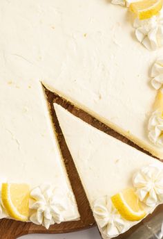 a cake with lemons and white frosting on it