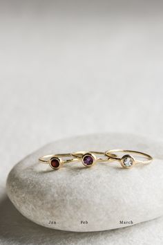 The bezel set birthstone ring is the perfect piece to celebrate those you love or yourself... or both! Add rings to stack as your family grows or incorporate your bestie or your extended family. This ring is very versatile and meaningful. Celebrate your loved ones everyday by keeping them close every day! Style this ring with another JP BIRTHSTONE RING for a fun colorful stack or create a modern look with the JP KNIFE EDGE BAND. PLEASE NOTE THE BIRTHSTONE SELECTION [CHOOSE DIAMOND OPTION FOR APR Fine Jewelry Birthstone Ring With Bezel Setting, Fine Jewelry Round Birthstone Ring With Bezel Setting, Ruby Birthstone Ring With Bezel Setting, Fine Jewelry Birthstone Ring With Bezel Setting For Anniversary, Anniversary Fine Jewelry Birthstone Ring With Bezel Setting, Fine Jewelry Birthstone Ring With Smooth Bezel, Stackable Rings With Smooth Bezel For Gift, Dainty Bezel Set May Birthstone Ring, Birthday Rings With Bezel Setting