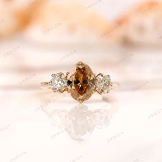 an orange diamond ring with three diamonds on it