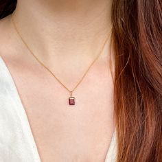 This beautifully simple necklace is lovingly handmade with a stunning AA+ grade Garnet gemstone and a 9ct Gold Chain. M A T E R I A L S: * Emerald Cut Garnet * Grade - AA+ * Origin - Mozambique * 9ct Solid Gold Chain S I Z E: *  Pendant - Approximately 8x6mm *  Chain Thickness - Approximately 1.1mm  All of our jewellery is carefully handmade using good quality materials and handpicked gemstones, with the aim to produce quality pieces that you can love & wear for years to come.  G A R N E T: * January Birthstone * Talisman for Aries, Virgo, Leo * Base Chakra, Heart Chakra Garnet cleanses and re-energises the chakras.  It revitalises, purifies and balances energy, bringing serenity or passion as appropriate.  Inspires love and devotion. Your necklace will arrive in a white jewellery box read Emerald Cut 14k Gold Necklace For Gift, Classic Necklace With Rectangular Stone As Gift, Minimalist Necklace With Rectangular Stone As Gift, Minimalist Necklace With Rectangular Stone For Gift, Yellow Gold Necklace With Rectangular Birthstone, Rectangular Birthstone Jewelry Gift, Minimalist Rectangular Stone Necklace For Gift, Dainty Rectangular Birthstone Necklace, 14k Gold Gemstone Rectangular Pendant Necklace