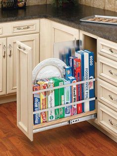 a kitchen cabinet filled with books and magazines