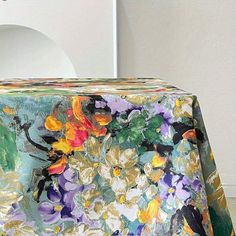 a table cloth with flowers on it in front of a white wall and toilet bowl