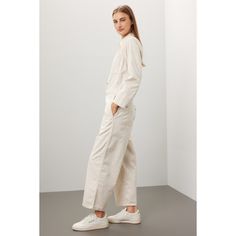 White denim (100% Cotton). Jumpsuit. Long sleeves. Collar. Front button closure. 53" from shoulder to hemline. 25.25" inseam. 19.75" leg opening. Imported. Relaxed Fit Button-up Fall Bottoms, Relaxed Fit Button-up Bottoms For Fall, Summer Cotton Button-up Pants, Utility Workwear Bottoms With Buttoned Pockets, Utility Bottoms With Buttoned Pockets For Work, Straight Leg Cotton Denim Jumpsuit With Button Closure, Utility Cotton Denim Jumpsuit With Button Closure, Casual Button-up Bottoms With Patch Pockets, Straight Leg Denim Jumpsuit With Button Closure