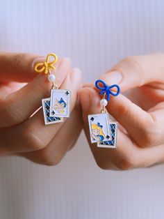 ⭐️ Introducing our kawaii earrings that are added to the new collection ENAMEL KAWAII Link: https://www.etsy.com/shop/EasternDragonShop?ref=shop-header-name&listing_id=1529609045&from_page=listing&section_id=48840336 ⭐️ The dangles showcase intricately designed cute elements, adding a unique touch to your look. The design features a rabbit shape hoop with a string of poker cards in the middle.  ⭐️ Crafted with hypoallergenic materials, these earrings offer a comfortable and safe wearing experien Cute Alice In Wonderland, Rabbit Shape, Kawaii Earrings, Poker Cards, Cheshire Cat, Wedding Shop, Daily Outfits, Alice In Wonderland, Poker