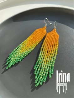 two pairs of beaded earrings on top of a plate