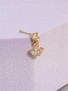 Introducing our charming variety of dangling nose studs, crafted to add a touch of romance to your look. Made from high-quality copper and adorned with sparkling cubic zirconia, this piece is the perfect blend of cute and romantic style. Its heart-shaped design adds an enchanting allure, making it a standout accessory for any occasion. Whether you're aiming for a cute everyday look or a romantic evening ensemble, this nose ring/stud is sure to capture hearts. Elevate your style and showcase your unique personality with these today! Piercings For Women, Dangle Nose Ring, Nose Studs, Beauty Pop, Baby Hair Clips, Nose Jewelry, Womens Golf Shoes, Nose Rings, Nose Ring Stud