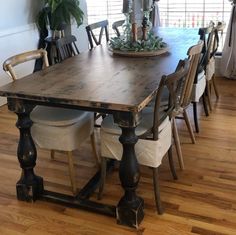 a wooden table with chairs around it in the middle of a wood floored room