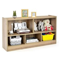 a book shelf with stuffed animals and books on it's sides, next to a potted plant