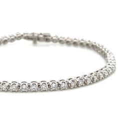 This beautiful Diamond Riviera Line Tennis Bracelet offers sparkling sophistication for any occasion with 1.95ct t.w. of dazzling diamonds, it will make you shine with undeniable elegance. Make your statement of style today! Metal: 14K White GoldDiamond Weight: Rounds Brilliant cuts 1.95ct t.w.Bracelet Length: 18cmLock: Box Catch With Hidden Safety Estimated production time is 4 - 5 weeks. Dazzling Cubic Zirconia Diamond Bracelet With Pave Setting, Dazzling Diamond Bracelets With Pavé Setting, Dazzling Diamond Bracelets With Pave Setting, Classic Moissanite Diamond Bracelet With Jubilee Style, Classic Moissanite Tennis Bracelet, Sterling Silver Bracelet With Pave Diamond Setting, Dazzling Diamond Bracelet With Pave Setting, Formal Diamond White Diamond Bracelet With Pave Setting, Luxury Lab Grown Diamond Bracelet For Formal Occasions