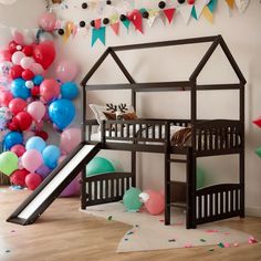 a child's room decorated with balloons, streamers and a wooden bunk bed