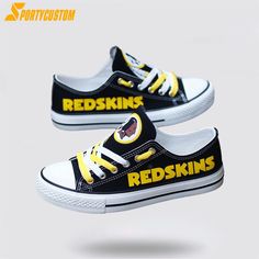 two black and yellow shoes with the words redskinss painted on them are shown