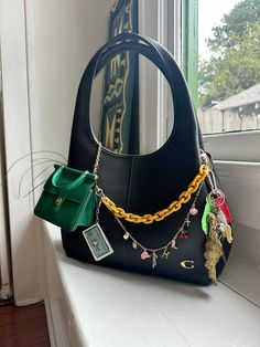 Coach bag with mini coach bag and charms and chains and keys Coach Bag Charm Ideas, Decorated Purse Aesthetic, Tote Bag With Charms, Coach Bag With Charms, Accessorised Bag, Coach Bag Charms, Purse With Charms, Coach Bag Charm, Coach Lana Bag