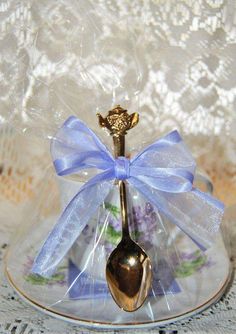 a spoon with a blue bow on it