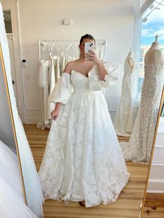 a woman taking a selfie in her wedding dress