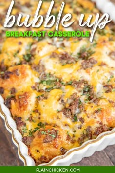 a casserole dish with sausage and cheese on top, in a white baking dish