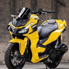 a yellow and black motorcycle parked in front of a building