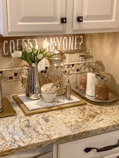 a kitchen counter with flowers and other items on it